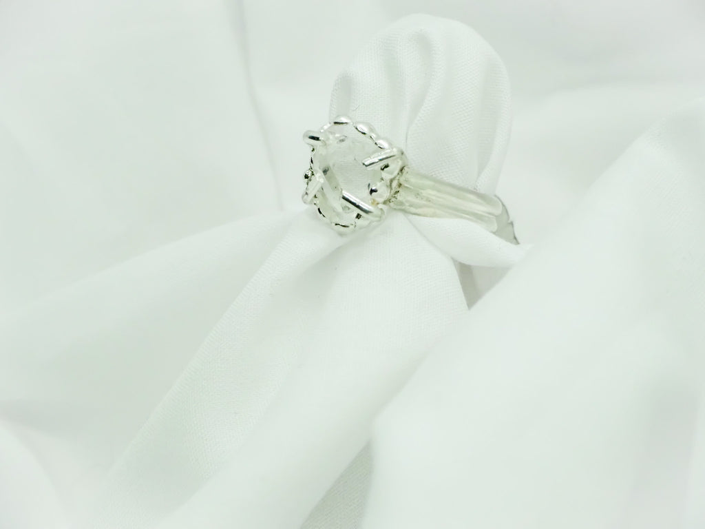 "A stunning combination of modern and vintage styles, this Herkimer diamond ring is a true statement piece. The gemstone is set in a cradled setting of sterling silver, designed to elevate the beauty and elegance of the facets. The ring is a size 7 and embodies a modern vintage style, making it perfect for those who appreciate timeless design with a contemporary twist."